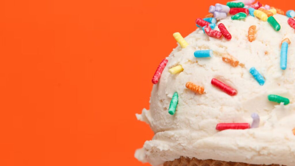 A dairy-free ice cream cone on an orange background perfect as for summer desserts